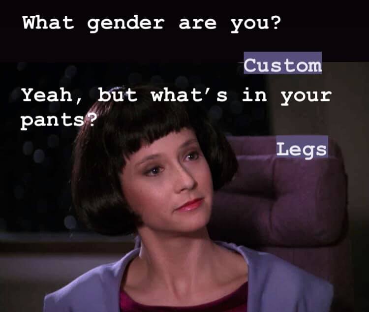 This meme is a screenshot from the TV show "Star Trek: The Next Generation" featuring a character, Deanna Troi, who is a Betazorian. The image shows her with a confused expression and the text "What's your problem, Beverly?" is written above her head. The meme is a play on the classic "What's your problem?" phrase, but with a humorous twist, replacing "problem" with "your [insert identity here]" and "I'm your [insert identity here]" to create a joke about someone's identity.